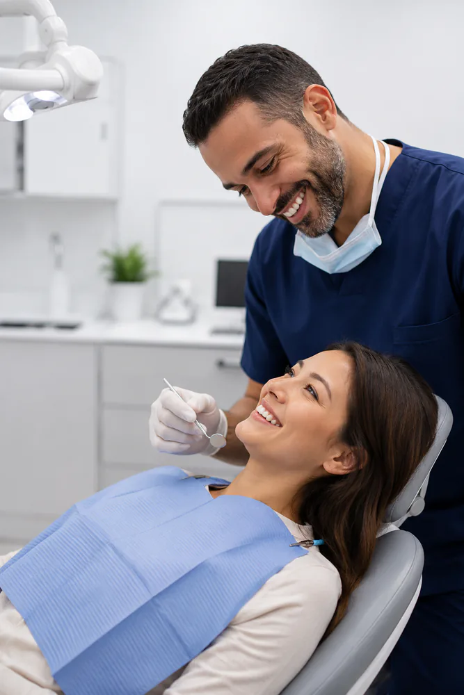 dentist-smiling-while-examining-patient dentist smiling while examining patient